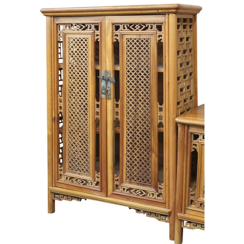 10 - A 20th century Oriental hardwood side cabinet with stylistic pierced doors and sides on shaped suppo... 