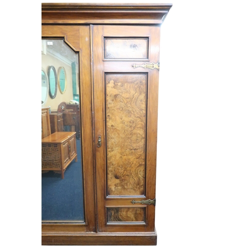 13 - A late 19th century mahogany and burr walnut veneered triple door wardrobe with cornice over central... 