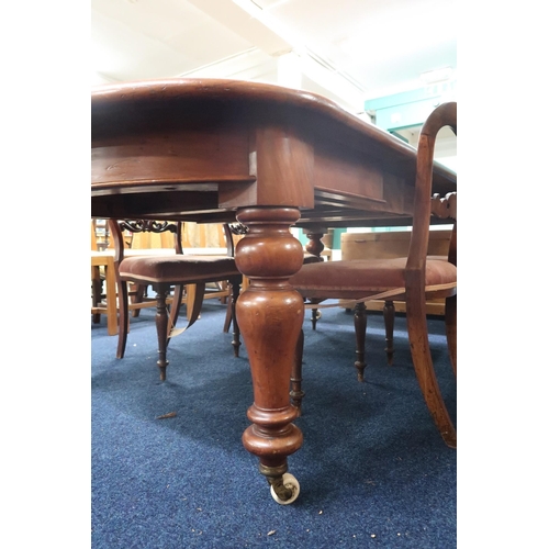 15 - A Victorian mahogany wind-out extending dining table on turned supports, 74cm high x 145cm long (241... 