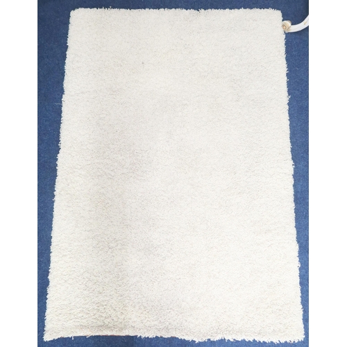 29 - A mid 20th century cream shag rug, 191cm long x 132cm wide