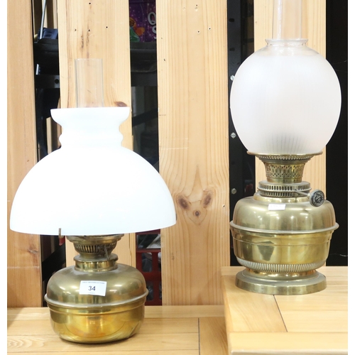 34 - A lot comprising a Victorian brass hanging oil lantern with opaque glass shade and another two brass... 