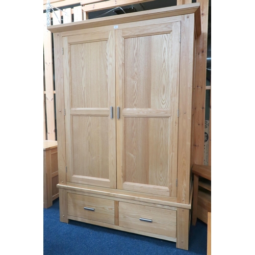 38 - A contemporary white ash wardrobe with chamfered cornice over pair of doors over two short drawers, ... 