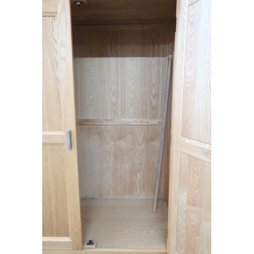 38 - A contemporary white ash wardrobe with chamfered cornice over pair of doors over two short drawers, ... 