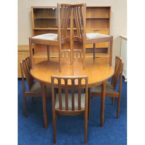 58 - A mid 20h century teak McIntosh circular extending dining table on shaped tapering supports, 76cm hi... 