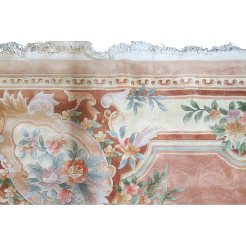 64 - An impressively large deep pile Aubusson style carpet with floral patterned central medallion within... 