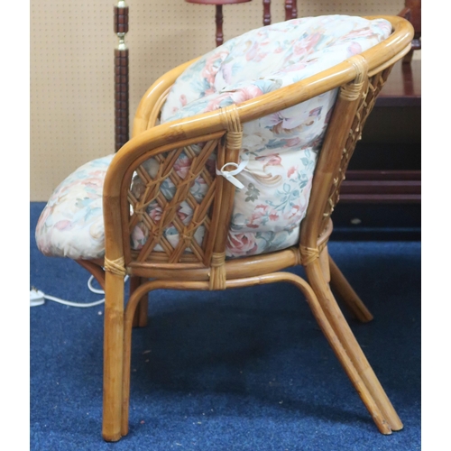 78 - A 20th century bamboo and cane three piece conservatory suite with floral patterned cushions (3)