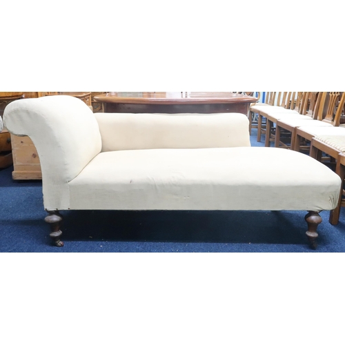 82 - A Victorian beige upholstered chaise longue with scrolled backrest on turned walnut supports termina... 