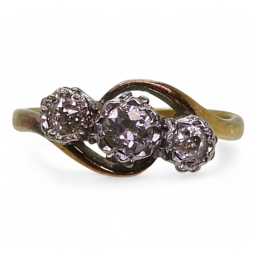 711 - An 18ct gold three stone diamond ring on a twist, set with estimated approx 0.25cts of old cut diamo... 