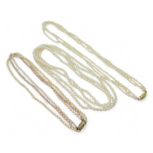 744 - Two strings of freshwater pearls to include one that is pink, cream and white both with gold plated ... 