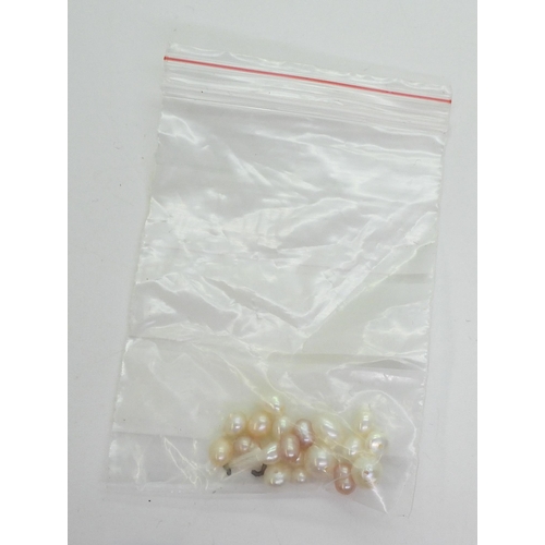 744 - Two strings of freshwater pearls to include one that is pink, cream and white both with gold plated ... 