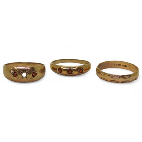 760 - Three 9ct gold rings, three star set garnets size P, similar with a stone missing size Q, and a wedd... 