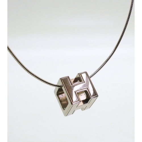 781 - A Hermes 'H' CUBE pendant and earrings both in original boxes, the pendant with a silver snake chain... 