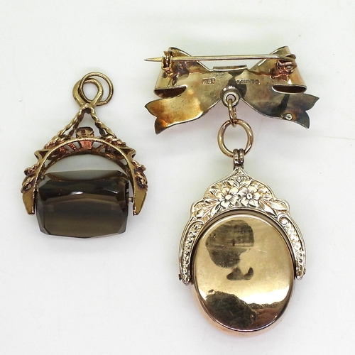 785 - A 9ct gold smoky quartz fob seal together with a 9ct gold Ward Brothers bow brooch with a 9ct carnel... 