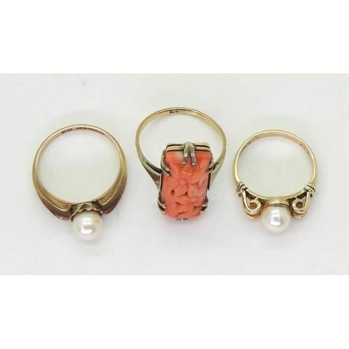 805 - A 9ct gold coral ring carved with flowers, size N, together with two 9ct gold pearl set rings sizes ... 