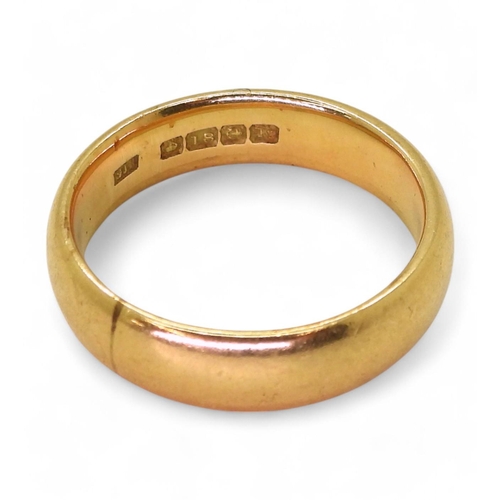 806 - An 18ct gold wide wedding ring, hallmarked Birmingham 1934, size T1/2, weight 9.4gms. 