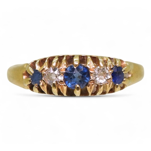 808 - A yellow metal ring set with old cut diamonds and blue gems, size n, weight 2.3gms