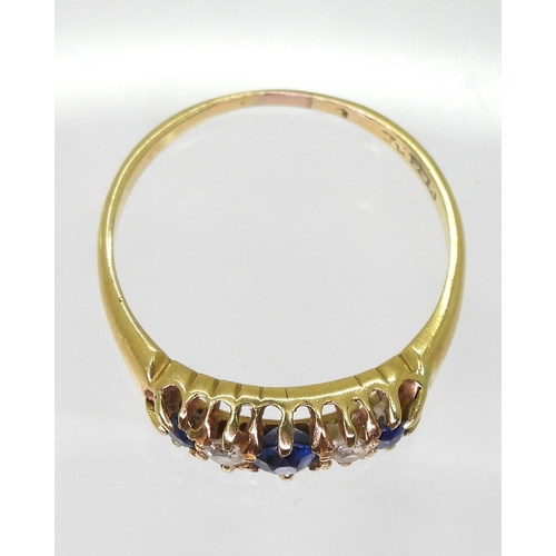 808 - A yellow metal ring set with old cut diamonds and blue gems, size n, weight 2.3gms