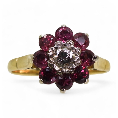 815 - A ruby and diamond flower ring, set in bright yellow metal, diamond estimated approx 0.10cts, finger... 