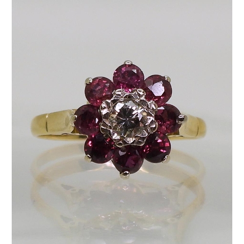 815 - A ruby and diamond flower ring, set in bright yellow metal, diamond estimated approx 0.10cts, finger... 