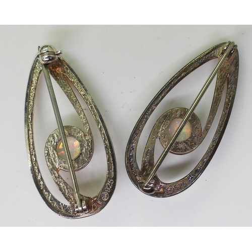 869 - Two silver brooches mounted with synthetic opal marked Ortak with boxes, together with a gold plated... 