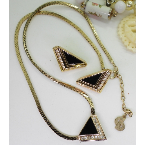 883 - A vintage gold plated necklace marked Christian Dior together with matching earrings, probably from ... 