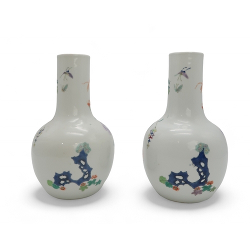 2455 - A PAIR OF CHINESE FAMILLE ROSE BALUSTER SHAPED VASES Painted with peacocks amongst flowering branche... 