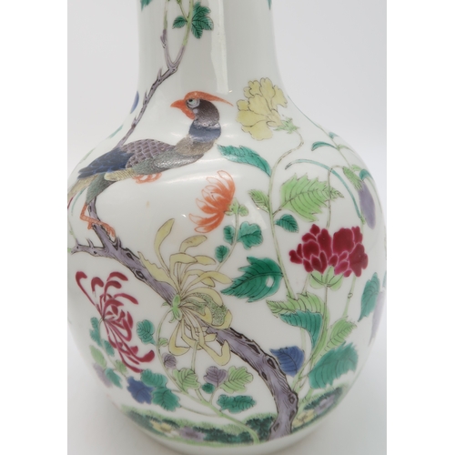 2455 - A PAIR OF CHINESE FAMILLE ROSE BALUSTER SHAPED VASES Painted with peacocks amongst flowering branche... 