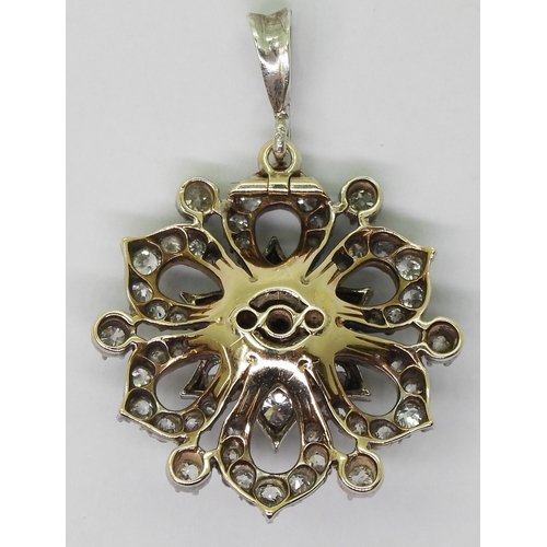 2768 - A DIAMOND FLOWER PENDANTmade in yellow and white metal and is set with estimated approx 1.38cts of o... 