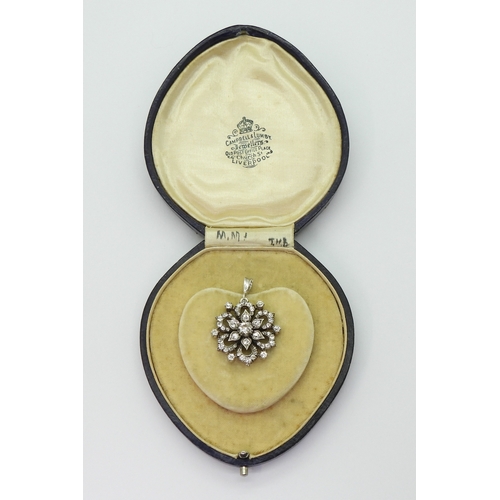 2768 - A DIAMOND FLOWER PENDANTmade in yellow and white metal and is set with estimated approx 1.38cts of o... 