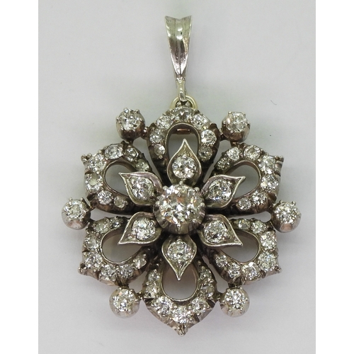 2768 - A DIAMOND FLOWER PENDANTmade in yellow and white metal and is set with estimated approx 1.38cts of o... 