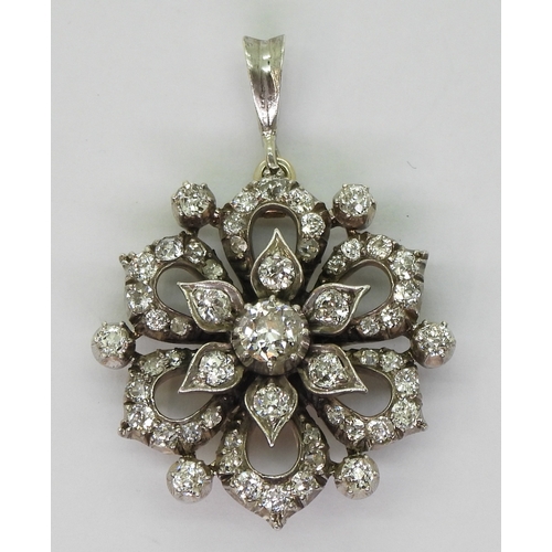 2768 - A DIAMOND FLOWER PENDANTmade in yellow and white metal and is set with estimated approx 1.38cts of o... 