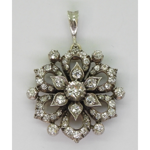 2768 - A DIAMOND FLOWER PENDANTmade in yellow and white metal and is set with estimated approx 1.38cts of o... 