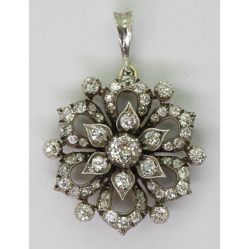 2768 - A DIAMOND FLOWER PENDANTmade in yellow and white metal and is set with estimated approx 1.38cts of o... 