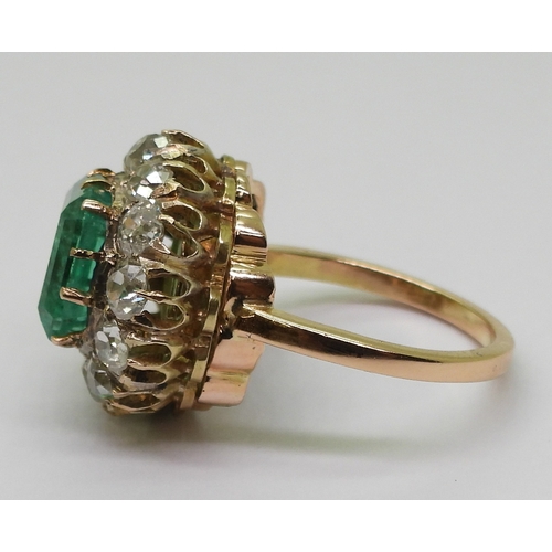 2770 - AN EMERALD STATEMENT RINGthe bright yellow metal mount is set with a step cut emerald of approx 8.7m... 