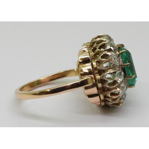 2770 - AN EMERALD STATEMENT RINGthe bright yellow metal mount is set with a step cut emerald of approx 8.7m... 