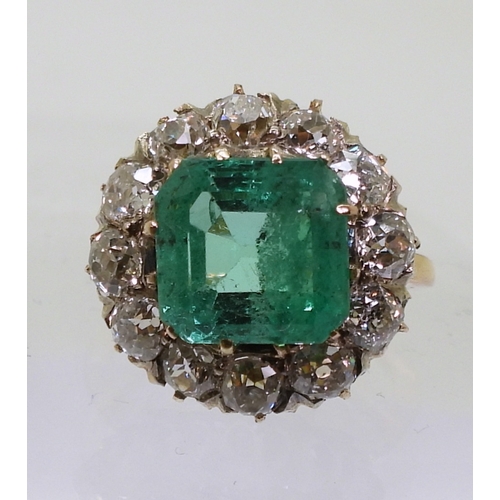 2770 - AN EMERALD STATEMENT RINGthe bright yellow metal mount is set with a step cut emerald of approx 8.7m... 