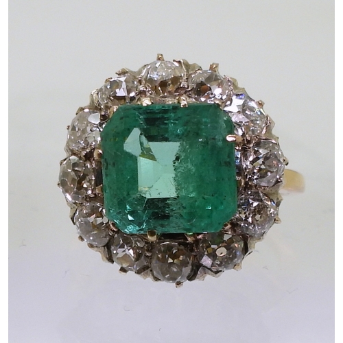 2770 - AN EMERALD STATEMENT RINGthe bright yellow metal mount is set with a step cut emerald of approx 8.7m... 