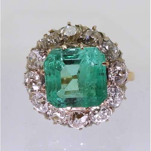 2770 - AN EMERALD STATEMENT RINGthe bright yellow metal mount is set with a step cut emerald of approx 8.7m... 