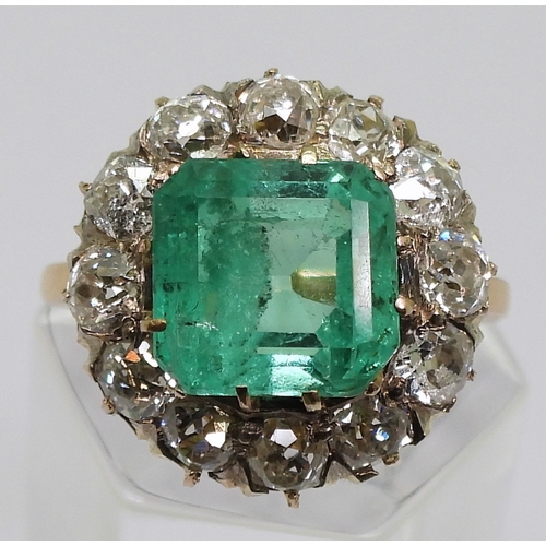 2770 - AN EMERALD STATEMENT RINGthe bright yellow metal mount is set with a step cut emerald of approx 8.7m... 