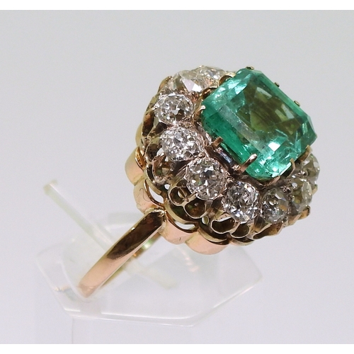 2770 - AN EMERALD STATEMENT RINGthe bright yellow metal mount is set with a step cut emerald of approx 8.7m... 