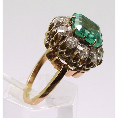 2770 - AN EMERALD STATEMENT RINGthe bright yellow metal mount is set with a step cut emerald of approx 8.7m... 