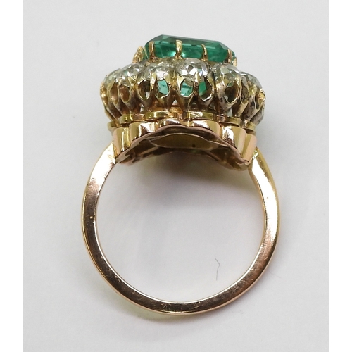 2770 - AN EMERALD STATEMENT RINGthe bright yellow metal mount is set with a step cut emerald of approx 8.7m... 