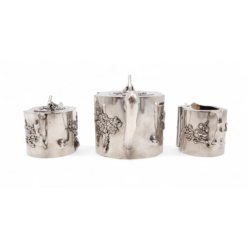 2538 - A CHINESE EXPORT THREE PIECE SILVER TEA SERVICEnaturalistically modelled, inspired by Yixing stonewa... 