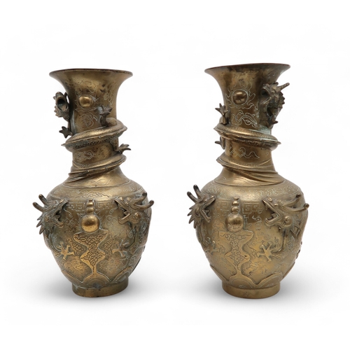 2445 - A PAIR OF CHINESE BRASS DRAGON VASES Cast with dragons chasing the flaming pearl of wisdom, 42cm hig... 