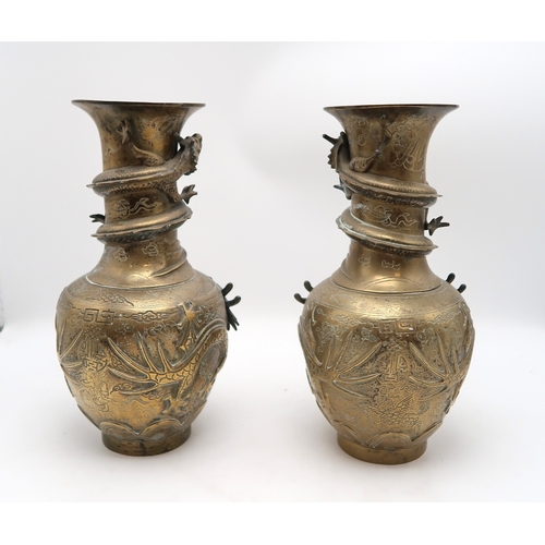 2445 - A PAIR OF CHINESE BRASS DRAGON VASES Cast with dragons chasing the flaming pearl of wisdom, 42cm hig... 