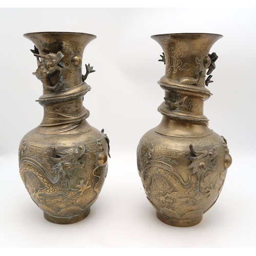 2445 - A PAIR OF CHINESE BRASS DRAGON VASES Cast with dragons chasing the flaming pearl of wisdom, 42cm hig... 