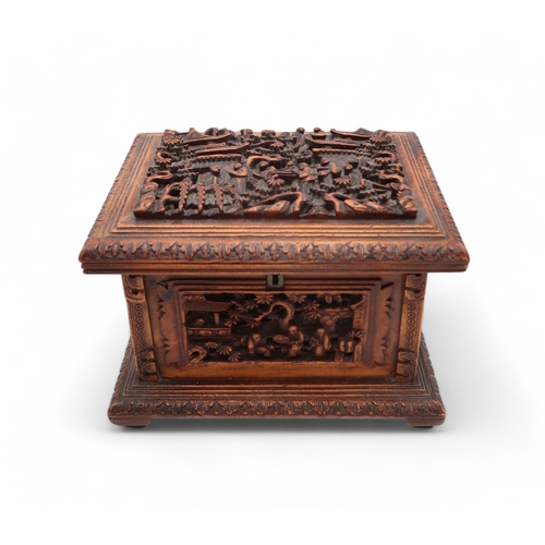 2448 - A CHINESE EXPORT SANDLEWOOD JEWELLERY BOX Carved with panels of figures amongst pavilions and trees,... 