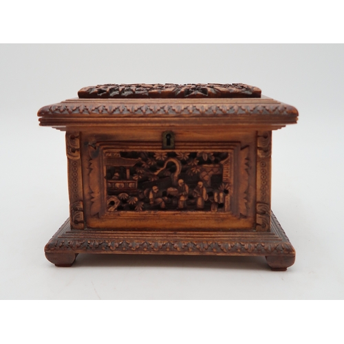 2448 - A CHINESE EXPORT SANDLEWOOD JEWELLERY BOX Carved with panels of figures amongst pavilions and trees,... 