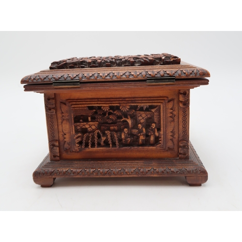 2448 - A CHINESE EXPORT SANDLEWOOD JEWELLERY BOX Carved with panels of figures amongst pavilions and trees,... 