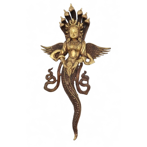 2452 - A BRASS NAAG KANYA WALL HANGING The snake Goddess holding a conch shell, 37cm high... 